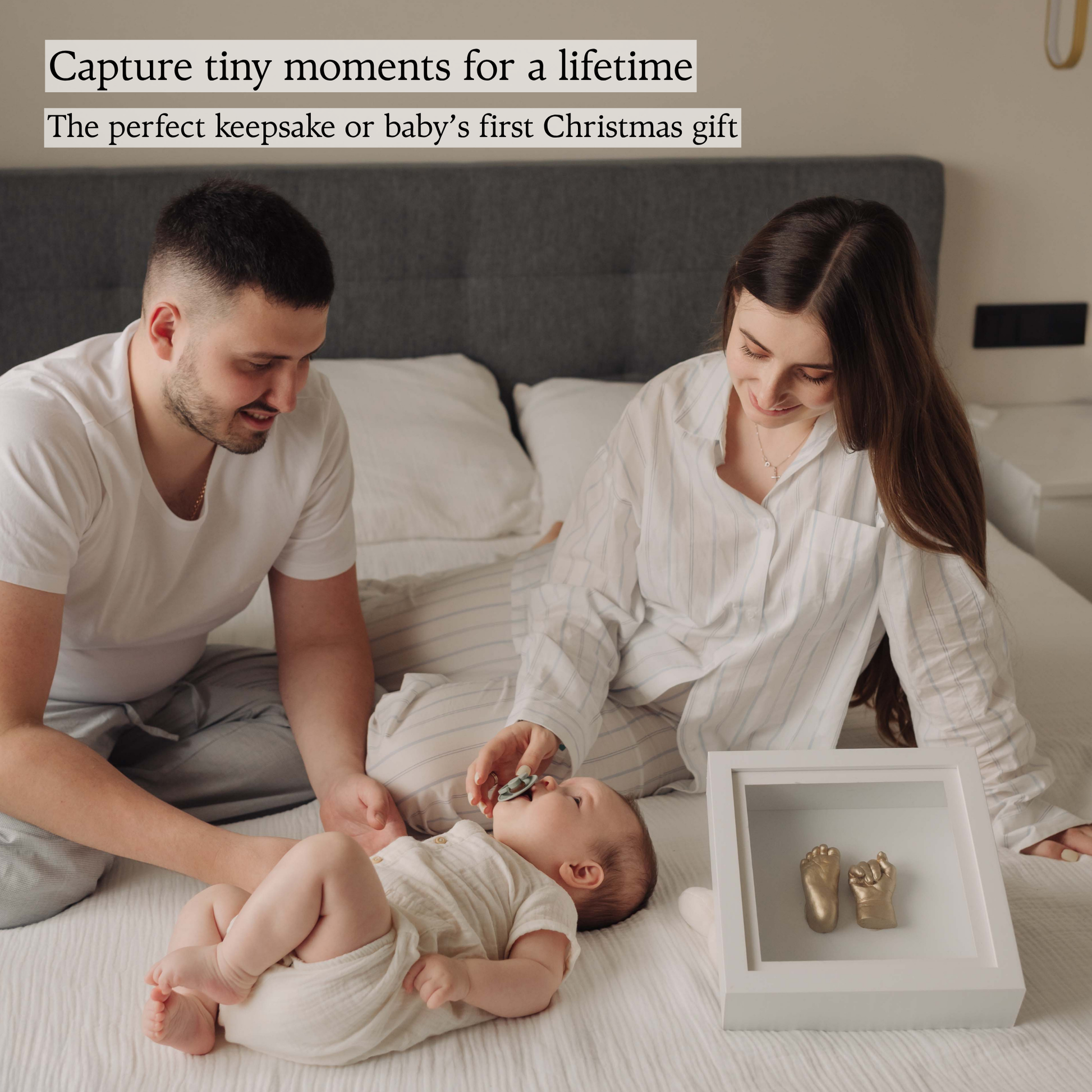 Family with baby and finished gold hand and foot casts displayed in Made by Mindy white frame – perfect Christmas keepsake gift